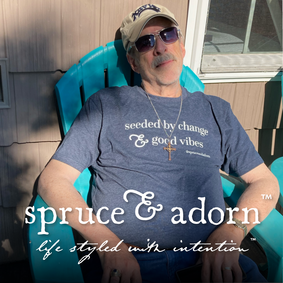 A  lounging grandpa in sunglasses and white ballcap basking in the sun and holding faith in his 'seeded by change & good vibes" @spruceandadorn t-shirt