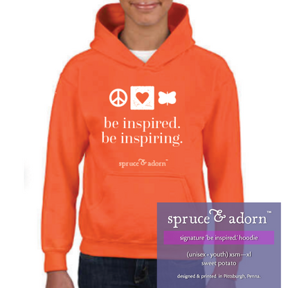 periwinkle description box, overlying sweet potato colored signature ‘be inspired. be inspiring’ @spruceandadorn no draw hoodie reading : signature ‘be inspired.’ hoodie (unisex • youth) xsm-xl sweet potatoe; designed & printed in Pittsburgh, Penna.