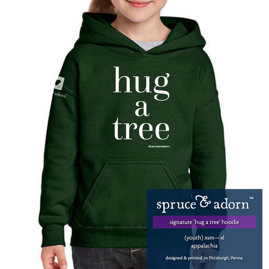 navy description box, overlying appalachia colored oversized signature ‘hug a tree’ @spruceandadorn hoodie reading : ‘hug a tree’ hoodie w/pocket’ (unisex • youth) xsm-xl appalachia with our logo on the right arm patch