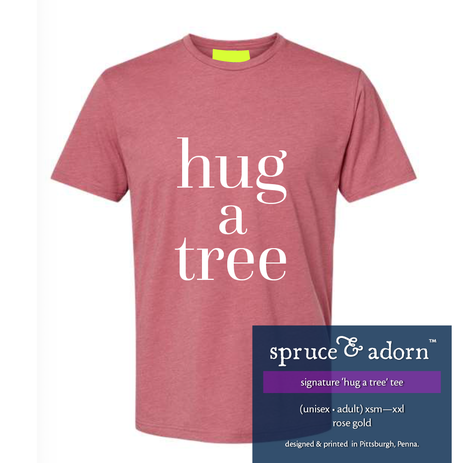 navy description box, overlying rose gold colored signature ‘hug a tree’ @spruceandadorn t-shirt reading : ‘hug a tree’ tee’ (unisex • adult) xsm-xxl rose gold designed & printed in Pittsburgh, Penna.